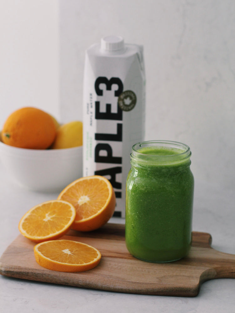 Green Smoothie based with Maple 3 Maple Water. Image of green smoothie with slices of oranges