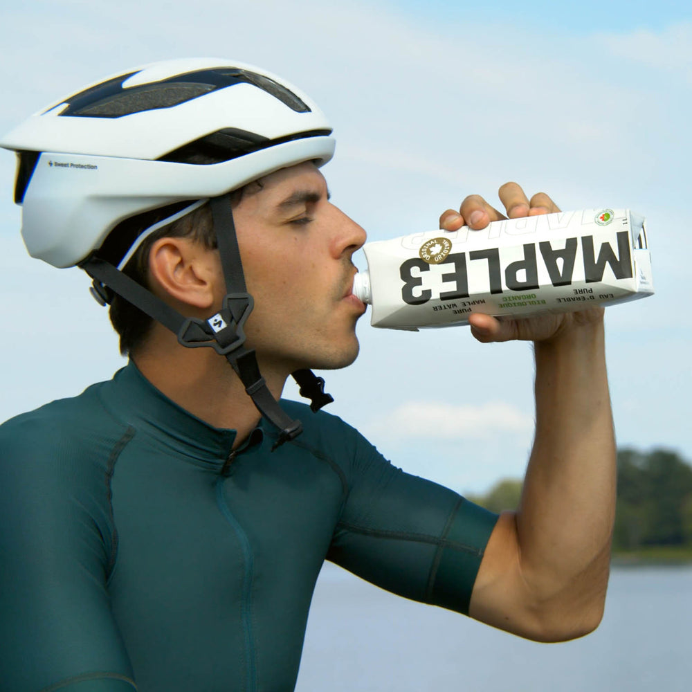A man drinking pure maple water 1L during his bike ride.