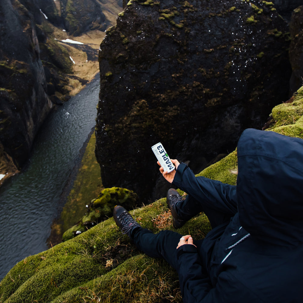 Drinking lime sparkling maple water from a cliff.